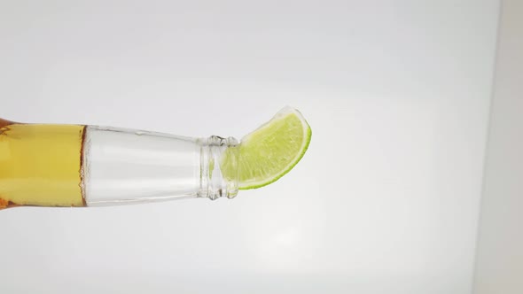 Vertical Video Beer with Lime on a White Background