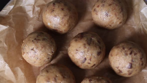 Useful Homemade Sweets.  Coconut Flour With Dark Chocolate.  In The Form Of Balls.  On Pine Boards