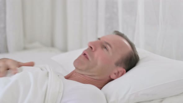 Worried Middle Aged Man Having Nightmare in Bed 