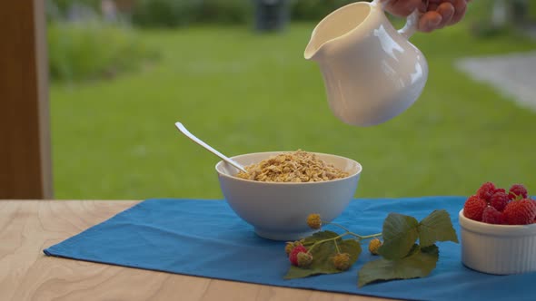 Milk Pouring Into a Bowl with Muesli