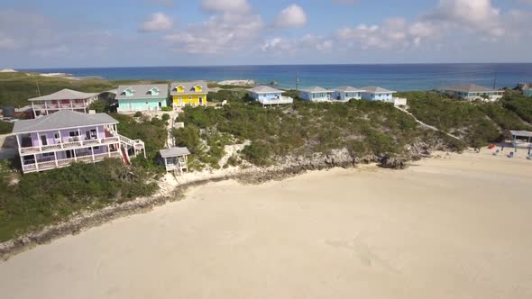 Aerial drone view clear water, houses on tropical island beach and coast in the Bahamas, Caribbean. 