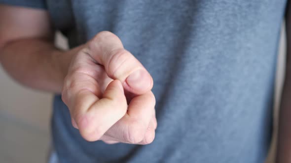 Young Man Scratches Agnail on Finger Suffering From Neurosis