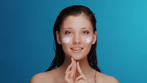 Fresh and Beautiful Girl Applying Cream After Shower with Hair Wet and Smiling To Camera