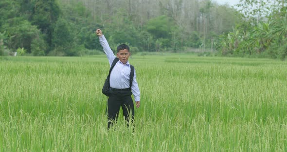 Asian Boy Student Win In Rice Field
