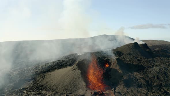 Incredible drone shot of smoking volcano after eruption. Magma spewing out of crater. Sunny day