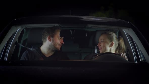 Smiling Woman Driver and Handsome Man Flirting in Car, Say Goodbye and Kissing