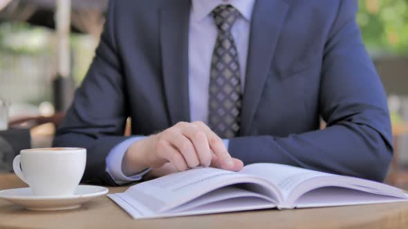 Close Up of Book Reading Businessman