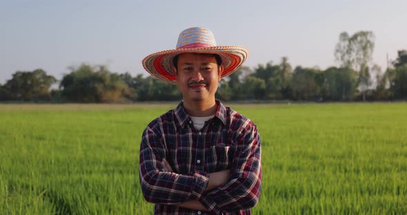 Portrait Happy Asian Farmer arms crossed smiling and looking at camera.