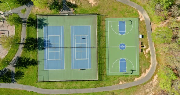 Outdoor Tennis Court and Basketball Field in the Park From a Height in Autumn