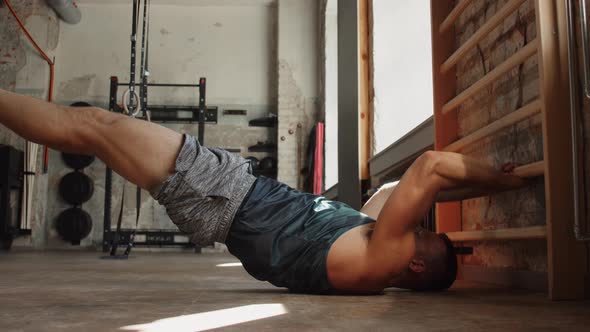 Man Exercising at Gymnastics Wall Bars in Gym