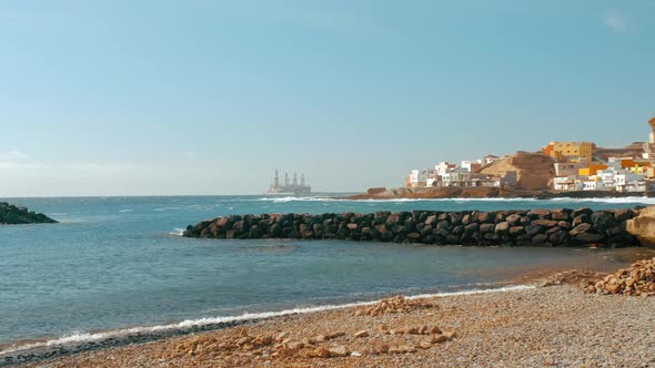 The Bay Is Next To the Ocean Shore. Fishing Boats and Cruise Yachts. European Small Town and Oil Rig