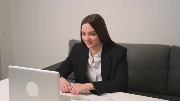 Smiling Young Businesswoman Has Video Calling for Remote Job Interview Using Laptop Webcam