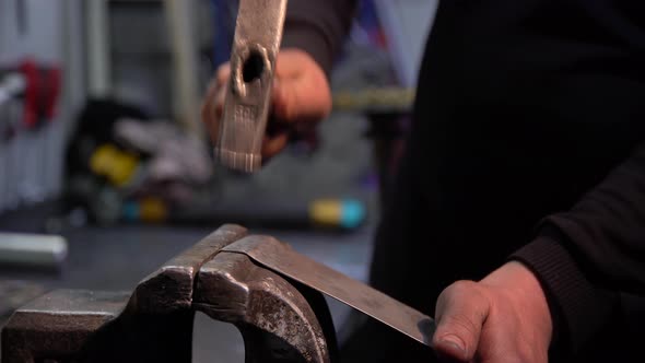 Worker Working With Hammer In Repair Shop