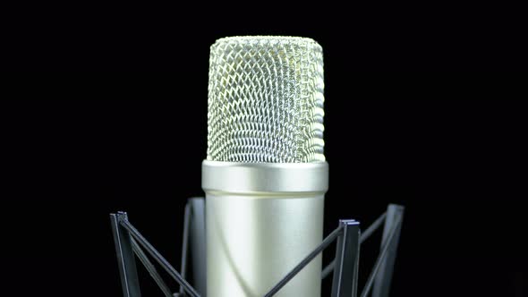 Studio Microphone with Spider Rotates on a Black Background