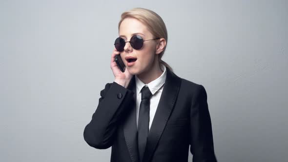 businesswoman in a classic business suit talking on mobile phone