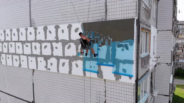 Aerial, Industrial Climber for Insulated Facades Putty Cement on Fiberglass Mesh