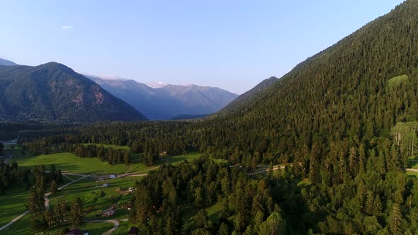 Aerial Panorama of Green Forest High Mountains and a Beautiful Valley