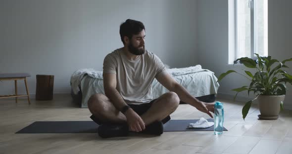 Exhausted Guy Drinking Water, Resting After Workout at Home