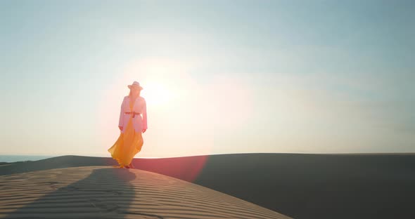 Relaxed Woman Having Walk in Desert at Sunset