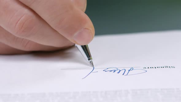 Businessman Signs a Document.