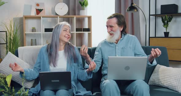 Mature Couple Relaxed on the Couch and Meditating with Closed Eyes when Making Pause