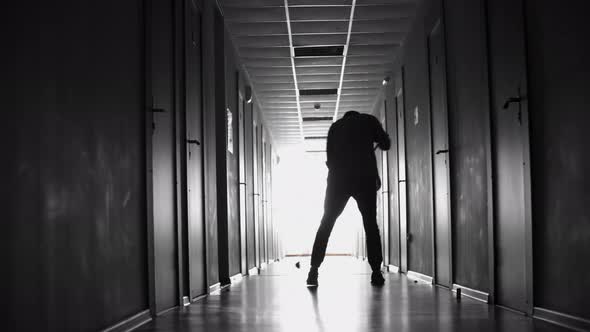 Janitor Sweeping Floor in Dark Hallway