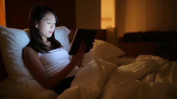 Woman use of tablet computer before sleep