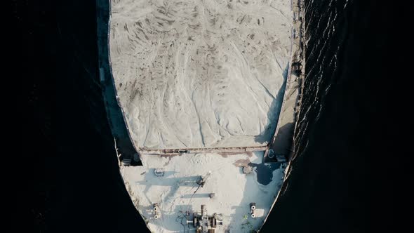 Top Aerial View of Shipping Barge Transporting Grit to Industrial Port