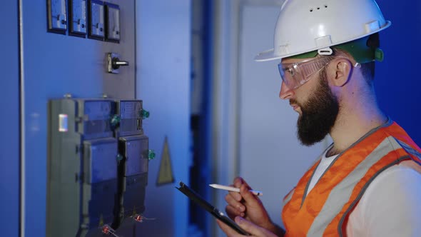 Checking Meter Reading By Electrical Engineer in Factory