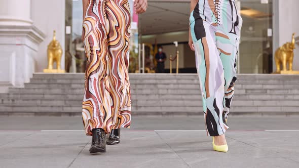 Models Walking Together In Brightly Coloured Clothing And Heels