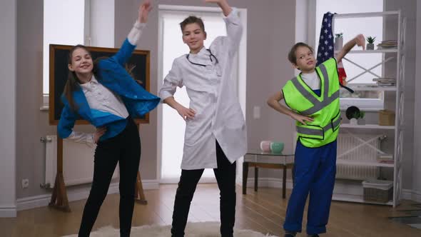 Three Confident Positive Teenage Friends Exercising Simultaneously Looking at Camera Smiling