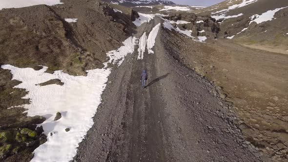 Man walking on a gravel road in Iceland