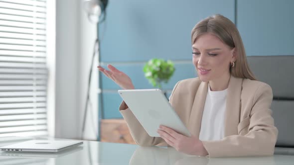 Businesswoman Making Video Call on Tablet in Office