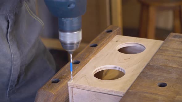 A Carpenter Using Drill and Auger