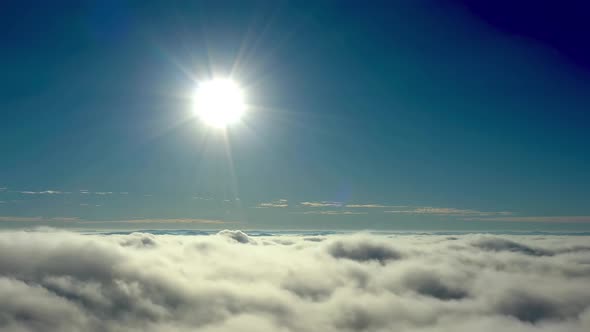 Sun above clouds Timelapse. Tropical scenery. Sunlight at blue sky