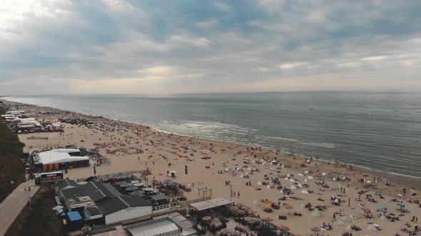 Drone footage flying over a coastline beach of the city of Zandoort, Netherlands along the North Sea