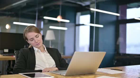 Sleepy Young Businesswoman Taking Nap in Modern Office 