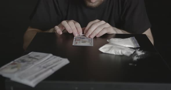 Young Addicted Man Taking Cocaine with Dollar