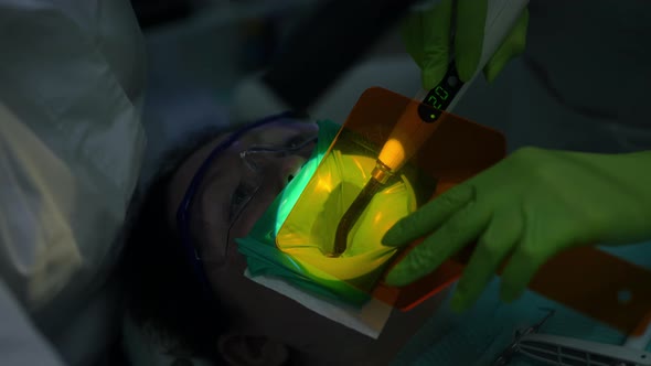 Closeup Curing Light Shield on Mouth of Patient with Dental Curing Light