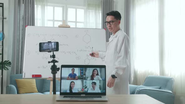 Teacher Shoots Video By Smartphone And Having Video Call On Laptop While Teaching Chemist Online