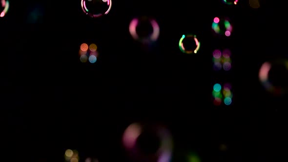 Colorful Soap Bubbles Fly. Slow Motion. Black Background