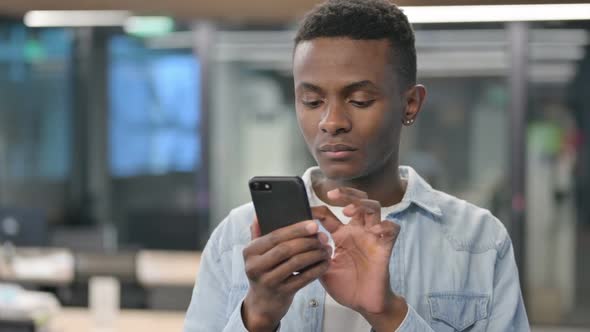 Portrait of African Man Celebrating on Smartphone