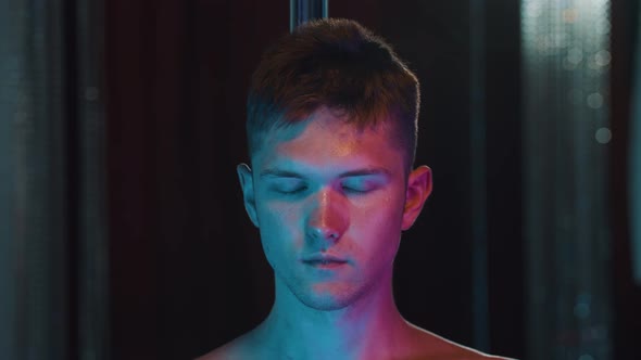 Shirtless Man Eating Coconut Candy  Neon Lighting