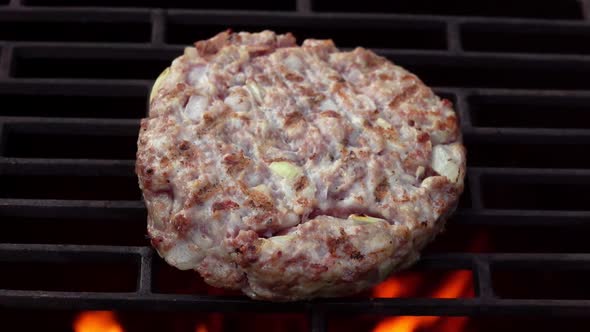 Top View of Halfprepared Burger Cutlet Made of Meat and Onions Roasting on Grill