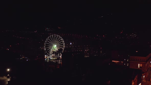 Zakopane ferris wheel at night, Poland. Aerial forward