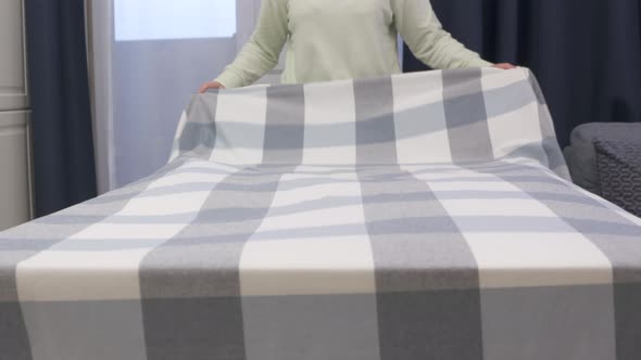 Woman Laying Tablecloth on Dining Table in Slow Motion