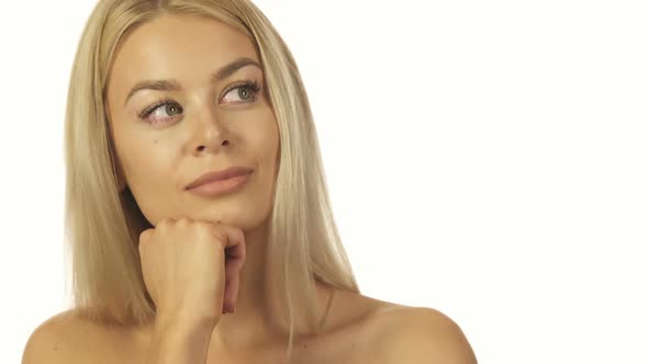 The Incredibly Beautiful Girl Thoughtfully Standing Against a White Wall