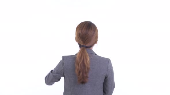 Rear View of Young Asian Businesswoman Pointing Finger and Directing