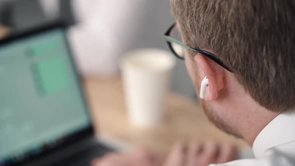 Closeup View of Young Businessman Is Talking and Working on Project at Table in Modern Office.