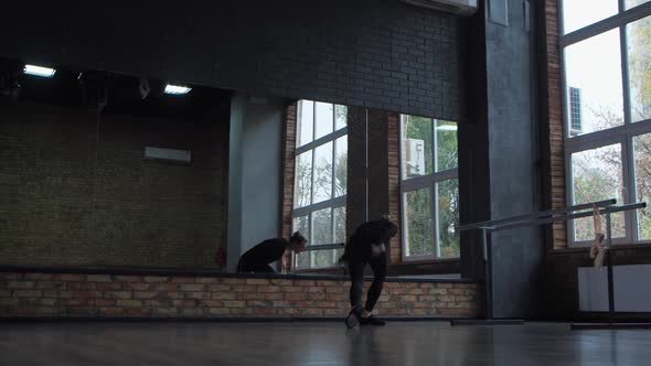 Elegant Ballet Dancer Practicing in Dance Hall